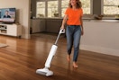 a person cleaning hardwood floors with a wet dry vacuum