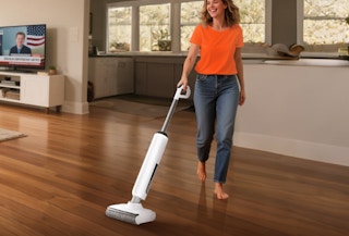 a person cleaning hardwood floors with a wet dry vacuum