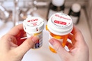 someone holding two prescription bottles, one from CVS and one from Walgreens