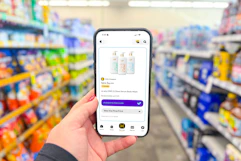 hand holding a smartphone displaying kcl coupons