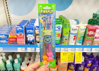 hand holding firefly multipack toothbrushes