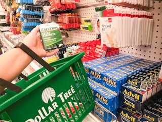 woman shopping at Dollar Tree holding basket and excedrin product