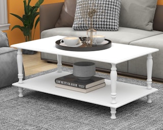 a white coffee table in a room in front of a couch