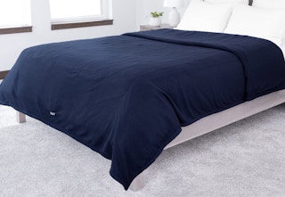 a dark blue electric blanket on a bed