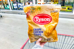 hand holding a bag of tyson chicken strips