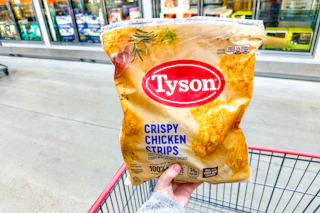 hand holding a bag of tyson chicken strips