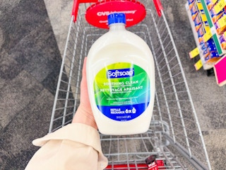 hand holding large softsoap hand soap refill in cvs
