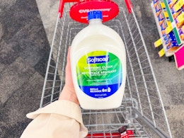 hand holding large softsoap hand soap refill in cvs