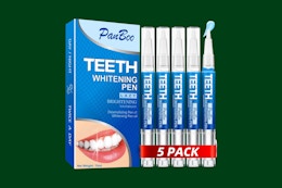 teeth whitening pen set on a green background