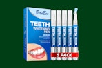 teeth whitening pen set on a green background