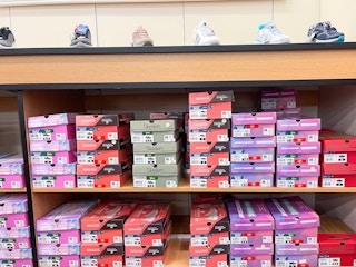 A variety of Sketchers boxes sitting on a. store shelf.