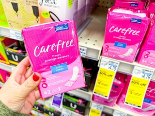 person holding carefree panty liners by the shelf