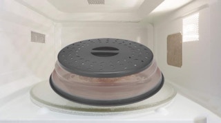 a grey and clear cover in a microwave