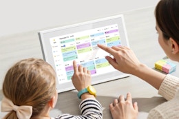 Mother and daughter using the flyEVfish Digital Calendar, 10.1 Inch Smart Electronic Desk Calendar.