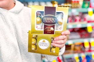 person holding 2 boxes of ferrero rocher chocolates