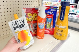 hand holding dally pack with pupperoni bounce colgate and la colombe on target shelf