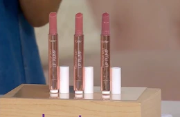 three tube of lipstick on a display 