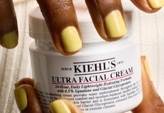 person opening kiehls cream