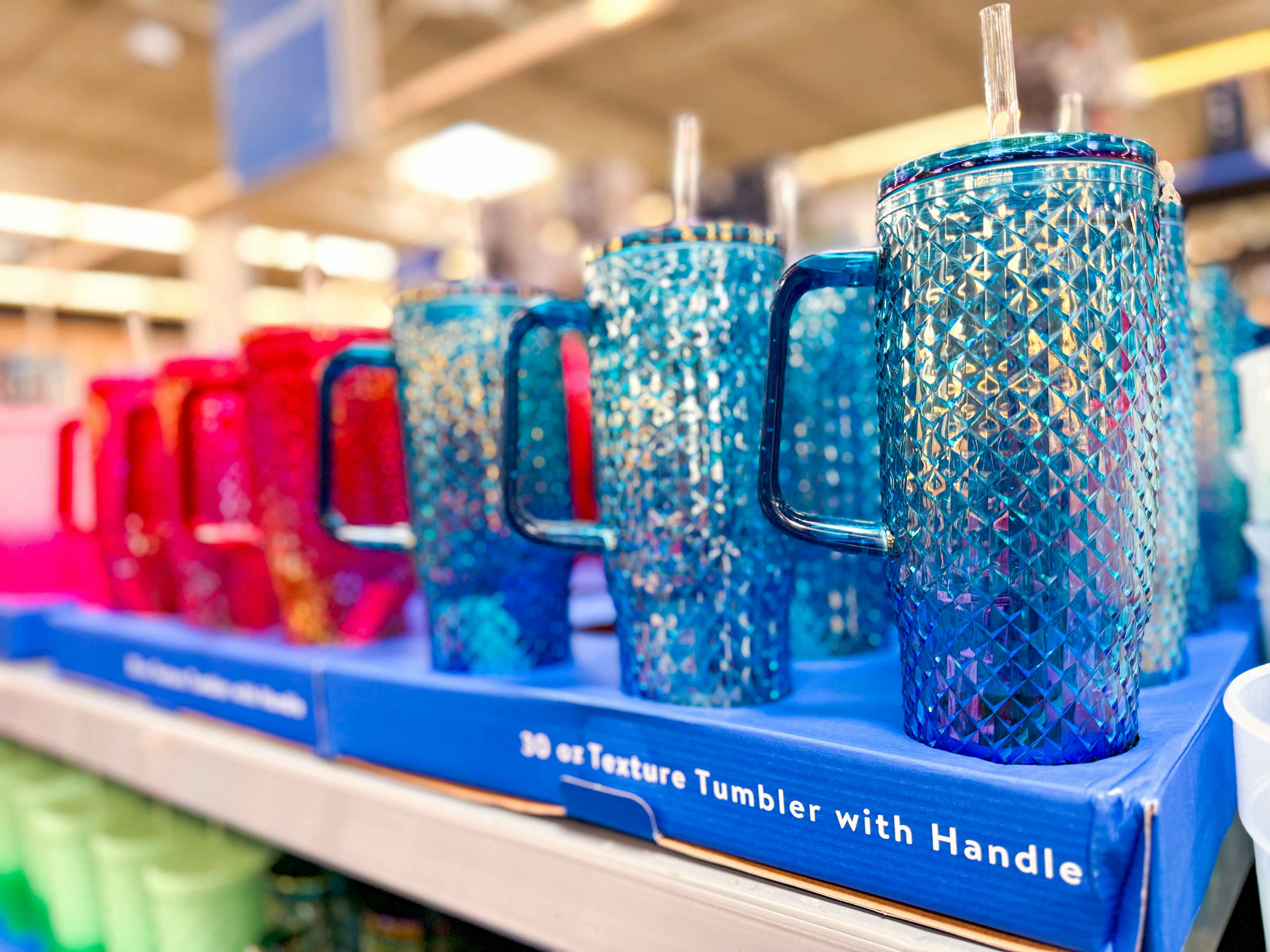 blue studded tumblers with handles on a shelf