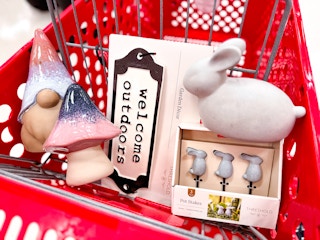 mushroom, gnome, bunnies, and signage in a red Target cart