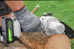 Person using the  CEEPUY Mini Chainsaw Cordless 6 Inch on a log.