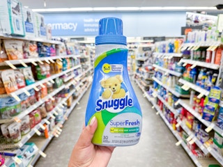 hand holding snuggle fabric softener in walgreens