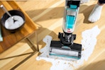 Lifestyle image of the Bissell CrossWave Hard Floor Cleaner used to clean up spilt milk