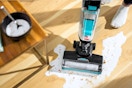 Lifestyle image of the Bissell CrossWave Hard Floor Cleaner used to clean up spilt milk