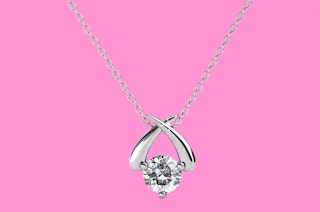 a necklace on a pink background