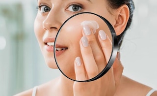 someone looking in a magnifying mirror on a big mirror