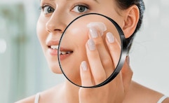 someone looking in a magnifying mirror on a big mirror