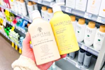 hand holding two hairitage hair care products