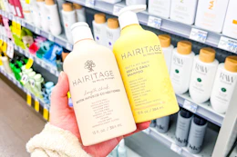 hand holding two hairitage hair care products