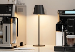 a cordless lamp next to a coffee machine 
