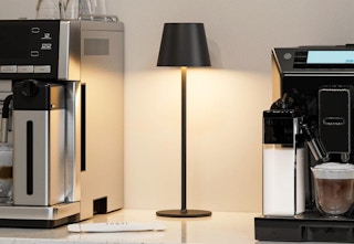 a cordless lamp next to a coffee machine 