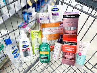 cart filled with a variety of Neutrogena, Aveeno, DermaGeek, and Cetaphil clearance products inside of it
