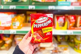 hand holding a pack of hormel pepperoni