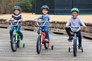 Lifestyle image of 3 children on Dynacraft bikes outside