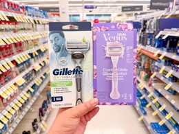 hand holding gillette and venus razors in walgreens