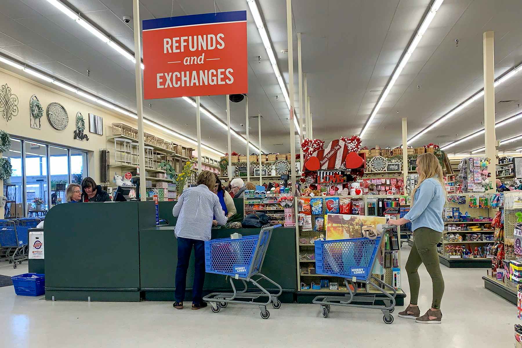 People in line at the Refunds and Exchanges checkout register.