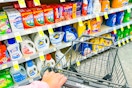 laundry detergent aisle and hand pushing a shopping cart