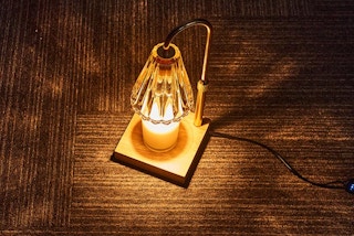 a candle warmer lamp turned on with a candle