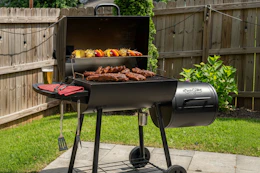 grill with food on it in a backyard