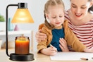 family working next to candle lamp wamer