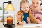 family working next to candle lamp wamer