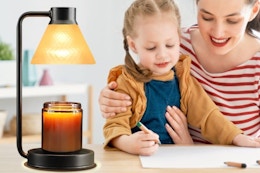family working next to candle lamp wamer