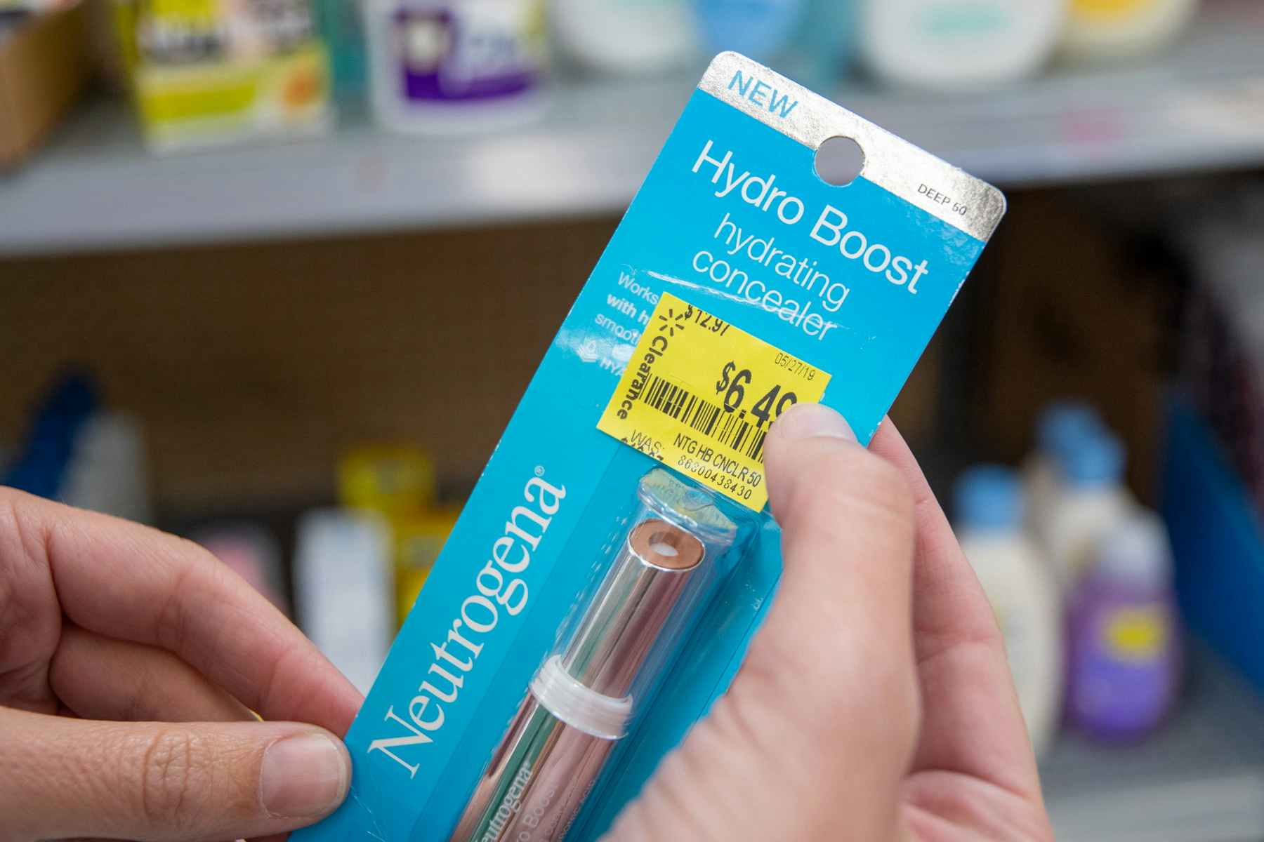 A person holding a Neutrogena Hydro Boost hydrating concealer with a Walmart clearance sticker on it.