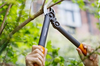 someone pruning a tree with the Fiskars PowerGear Super Pruner