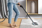 a woman using a steam cleaner