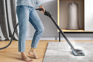 a woman using a steam cleaner